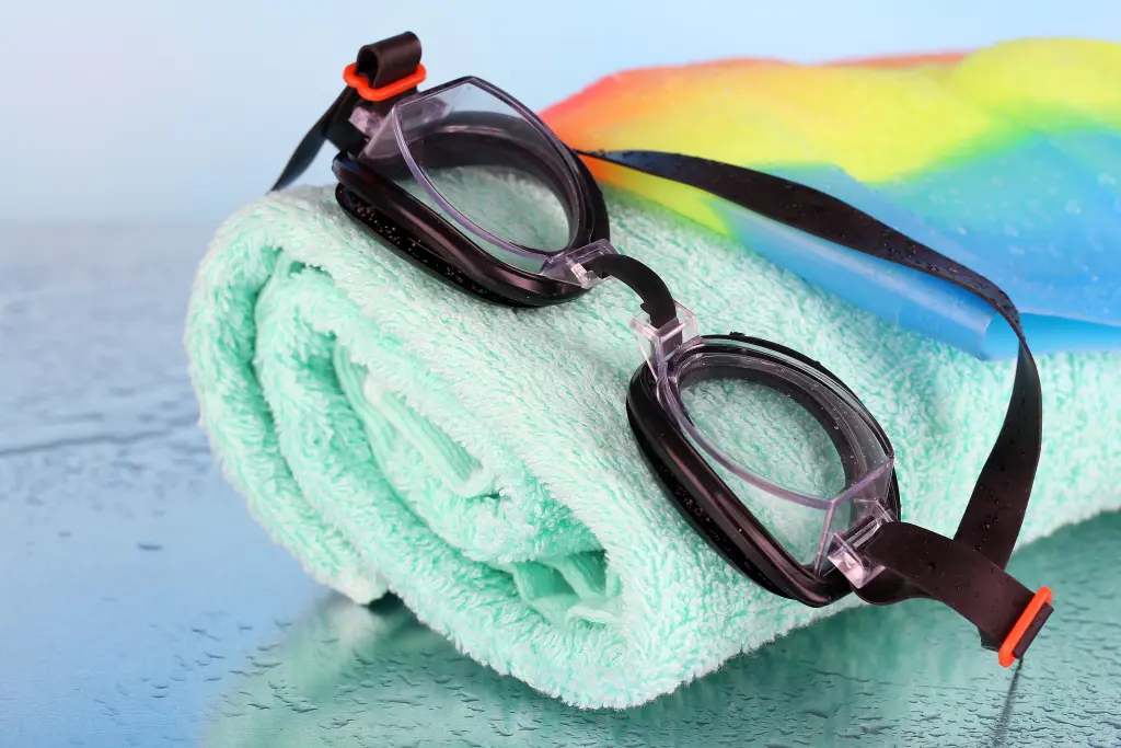 set-for-pool-swim-cap-goggles-and-towel-on-blue-background.jpg set-for-pool-swim-cap-goggles-and-towel-on-blue-background.jpg